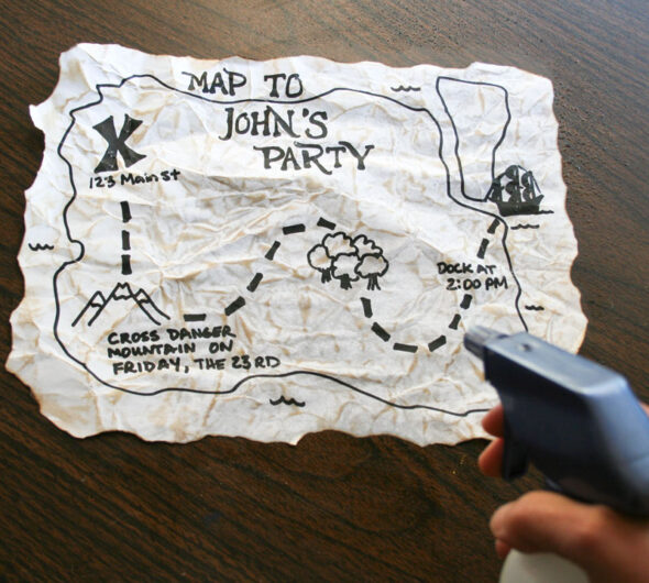 make a pirate map party invitation - spritz with water
