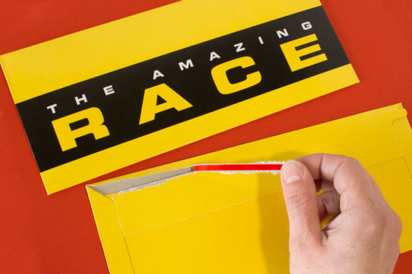 amazing race party ideas tear-strip envelopes