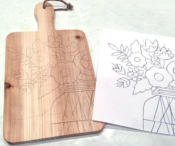 Wood-burning designs onto a cutting board