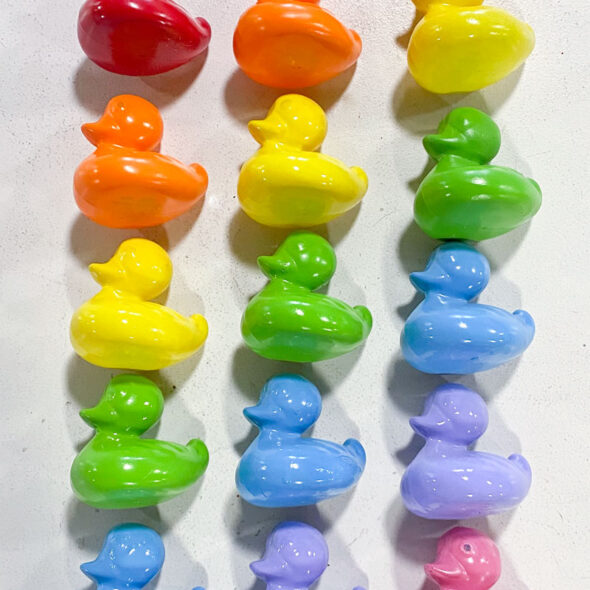 Rainbow kid's bathroom art from painted toy ducks