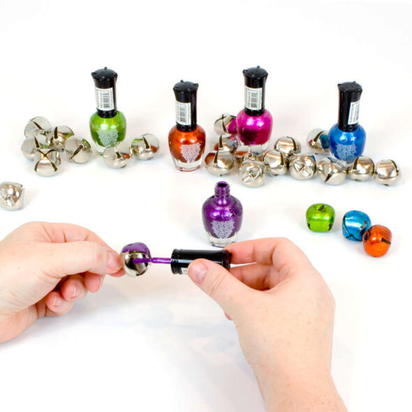 Create custom colored jingle bells with nail polish