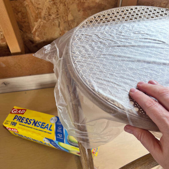 Rattan side table makeover with coral spray paint