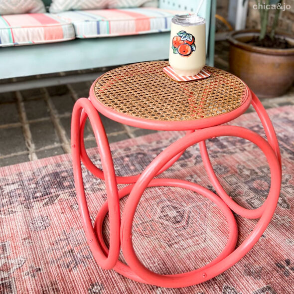 Rattan side table makeover with coral spray paint