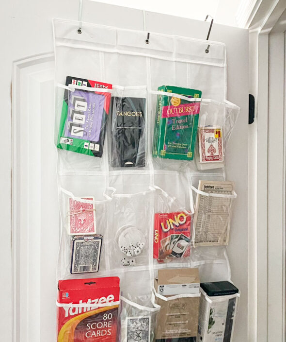storing small games and cards in an over-the-door shoe organizer