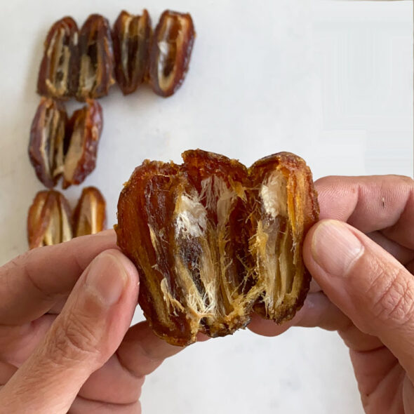 how to make date bark - cut the dates in half