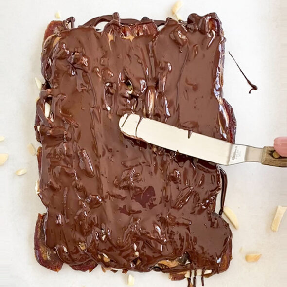 how to make date bark - spread the chocolate out with spatula