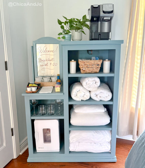 guest room essentials in a thrifted cabinet for amenities