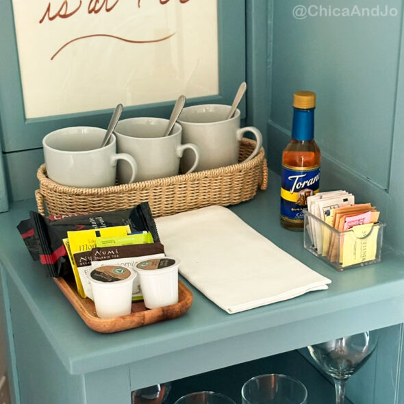 guest room essentials in a thrifted cabinet for amenities - coffee station