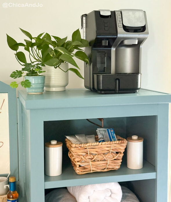 guest room essentials in a thrifted cabinet for amenities - coffee maker